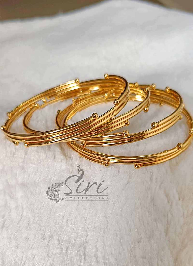 Beautiful Set of Four Bangles in Gold Micro Polish