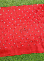 Load image into Gallery viewer, Red fabric with white floral patterns on a green grass background
