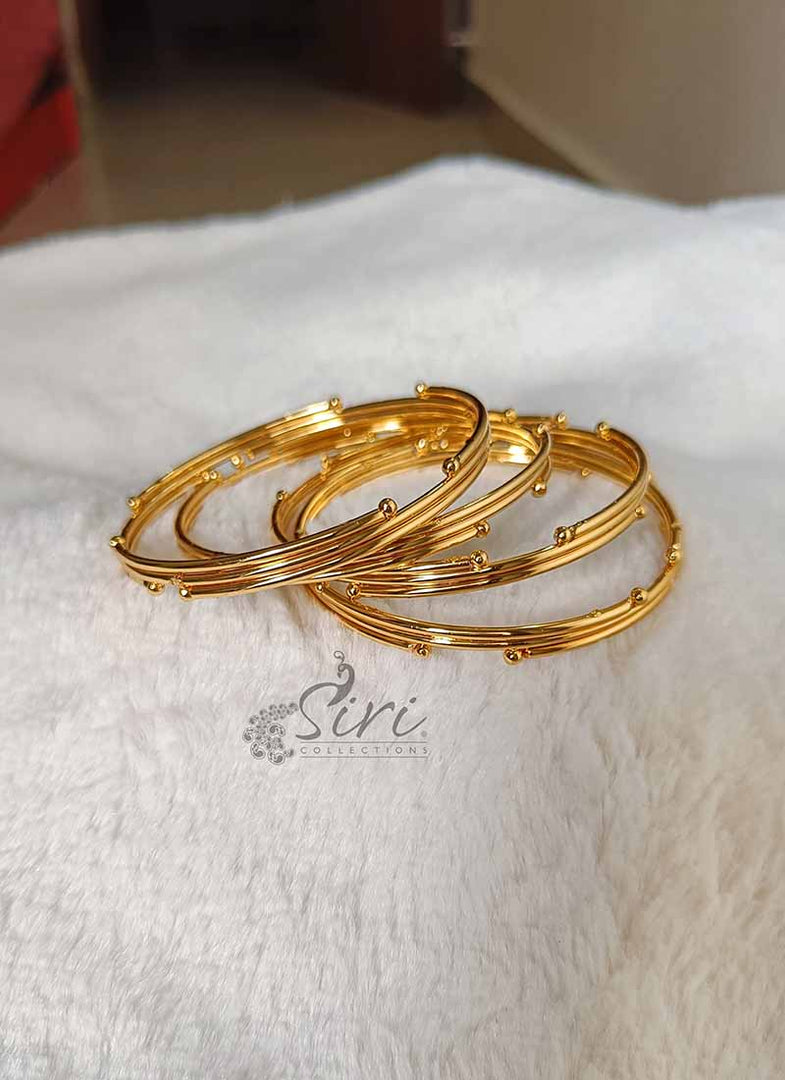 Beautiful Set of Four Bangles in Gold Micro Polish